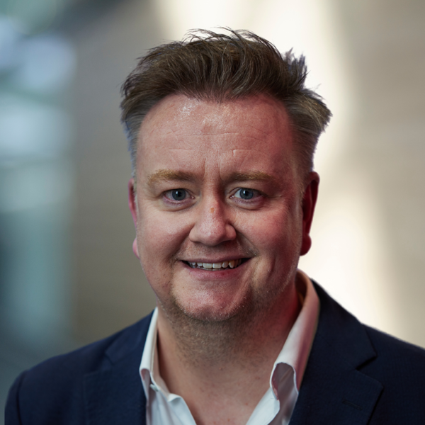 Headshot of JUSTIN COSNETT